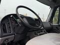 Interior view of a 2019 Freightliner M2 featuring a steering wheel dashboard gauges and control panel