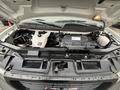 Close-up view of the engine compartment of a 2022 GMC Savana showing various engine components and fluid reservoirs
