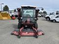 A 2012 Toro Groundsmaster 5910 featuring a cab with a transparent windshield and dual side mirrors equipped with rotary mowers on the front and sides