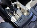 The interior console of a 2021 Chevrolet Colorado showing the gear shifter and cup holders