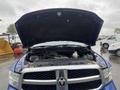 A 2019 RAM 1500 Classic with its hood raised revealing the engine compartment and various components inside