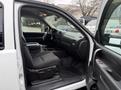 Interior view of a 2013 Chevrolet Silverado 3500HD with black fabric seats and a center console showing the dashboard and controls