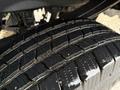 Close-up of a 2017 Ford F-350 SD tire showcasing deep tread patterns and slight moisture on the surface