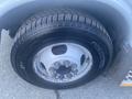 Close-up of a tire and wheel assembly from a 2017 Chevrolet Express showing tread pattern and bolt arrangement