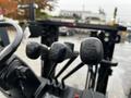 A close-up of the control levers of a 2017 Toyota 8FCGCU25 forklift with three knobs showing operational settings