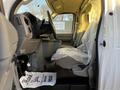 Interior of a 2017 Ford Econoline showing the driver's seat dashboard and steering wheel with plastic covering on the seat
