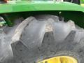 Close-up of a large, heavy-duty tractor tire with deep treads on a 2003 John Deere 790