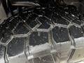 Close-up of a heavily treaded tire from a 2017 Ford F-150 showing deep grooves and a wet surface