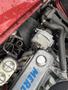 Close-up of the engine compartment of a 1970 Chevrolet Corvette showcasing the shiny components and mechanical details