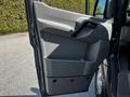 The image shows the interior door panel of a 2017 Mercedes-Benz Sprinter featuring a gray surface and a handle for opening the door