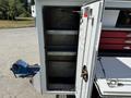 A 2020 Ram 2500 with an open utility box showing shelves and a vise mounted on the side