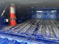 A blue 2019 RAM 1500 Classic pickup truck bed showing a dirty surface and a red fire extinguisher mounted on the side