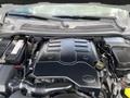 An open hood displaying the engine compartment of a 2006 Land Rover LR3 with visible components like the battery and air intake system
