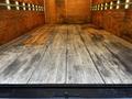 2007 GMC W3500 truck with an empty wooden cargo area featuring weathered wooden planks arranged in a rectangular layout