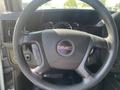 Steering wheel of a 2016 GMC Savana featuring the GMC logo and controls on the side