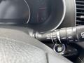 The interior of a 2015 Kia Sorento showing the steering wheel controls including windshield wiper settings and push button start