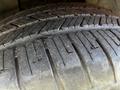 Close-up of a tire tread on a 2013 Lincoln MKT showing worn grooves and rubber surface details