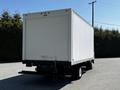 2007 GMC W3500 box truck with a plain white cargo area and a rear-loading door