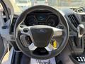 Steering wheel of a 2017 Ford Transit with the Ford logo visible and controls for audio and cruise settings