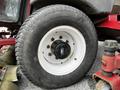 A close-up of a 2012 Toro Groundsmaster tire showing a white rim and black hub with visible tread on the rubber tire