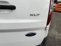 A white 2017 Ford Transit Connect with an XLT badge on the rear panel and a Ford logo beneath it