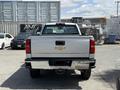 2016 Chevrolet Silverado 2500HD pickup truck viewed from the rear with a silver body and visible Chevrolet logo on the tailgate