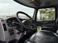 Interior view of a 2016 Peterbilt 348 showing the steering wheel dashboard controls and leather driver's seat