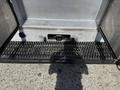 A metallic step platform attached to a 2009 Kenworth T270 truck featuring a diamond plate surface and a hitch receiver at the center