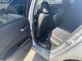 Interior view of a 2017 Acura TLX showing black leather seats and the vehicle's front console and dashboard
