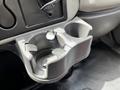 A gray cup holder designed for a 2019 International 4300 truck with two compartments to hold cups or beverages