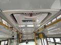 The interior ceiling of a 2018 Chevrolet Express featuring emergency exit signage and overhead safety equipment