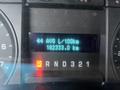 Dashboard display of a 2010 Ford F-150 showing average fuel consumption and total kilometers driven