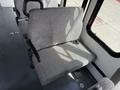 Interior of a 2010 Ford Econoline showing a gray fabric seat with armrests positioned on the left side of the image