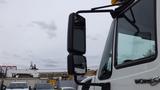 A 2012 International 7400 truck with a prominent side mirror visible in the foreground