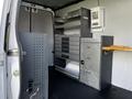 A 2017 Mercedes-Benz Sprinter van interior featuring metal storage units with drawers and shelves organized for tools and equipment
