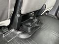 A cup holder integrated into the rear interior of a 2016 Ford F-150 with a textured flooring surface