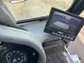 Interior view of a 2015 Global Street Sweeper showing the dashboard with a monitor displaying a rearview camera feed and a gauge for RPMs