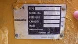 A metal identification plate on a Komatsu D37PX-22 displaying the type serial number pressure capacity mass and manufacturer details