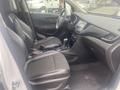 Interior of a 2018 Buick Encore featuring black leather seats a central console with a touchscreen and gear shift and a modern dashboard layout