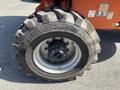 Close-up of a tire from a 2008 JLG Boom Lift showing deep treads and rim details with the size labeled as 12-16.5 NHS