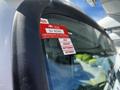 A 2005 Volvo VND 122 with a red certificate of approval sticker affixed to the driver's side window indicating the months July August September and October