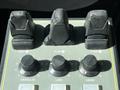 Control panel with three levers labeled Hoist, Plow, and Plow and five knobs labeled Granular, Lane, and Liquid with varying sizes and textures