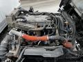 A 2018 Isuzu NPR engine partially disassembled with visible hoses wires and components showcasing the mechanical structure and complexity of the engine
