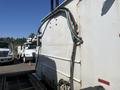 2007 International 7300 truck featuring a large flatbed and attached equipment with hoses running from the back