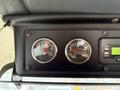 Dashboard of a 2010 Autocar Xpeditor featuring two circular gauges showing volts and air pressure readings