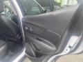 A 2018 Buick Encore door interior with black leather upholstery and door controls visible