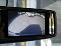 A 2019 Chevrolet Express is displayed on a rearview camera monitor showing vehicles parked behind it