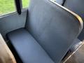 A blue upholstered bus seat with a smooth surface in a public transportation vehicle