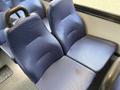 Two blue upholstered seats with a contoured design inside a vehicle