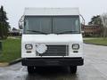 Front view of a white 2012 Ford Econoline with a flat front and a grill featuring horizontal slats, designed for commercial use